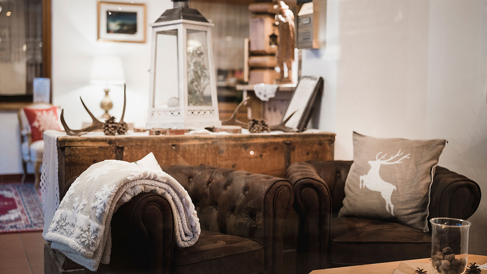 Detail of a brown leather chair at our hotel at Campolongo Pass and in the background a wooden furniture